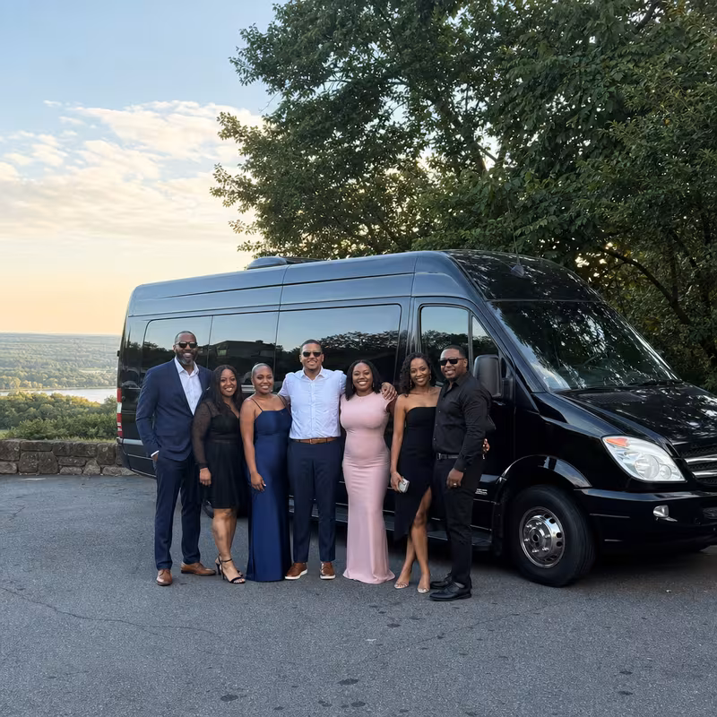 Group beside a Mercedes Sprinter limo from the Greensboro fleet