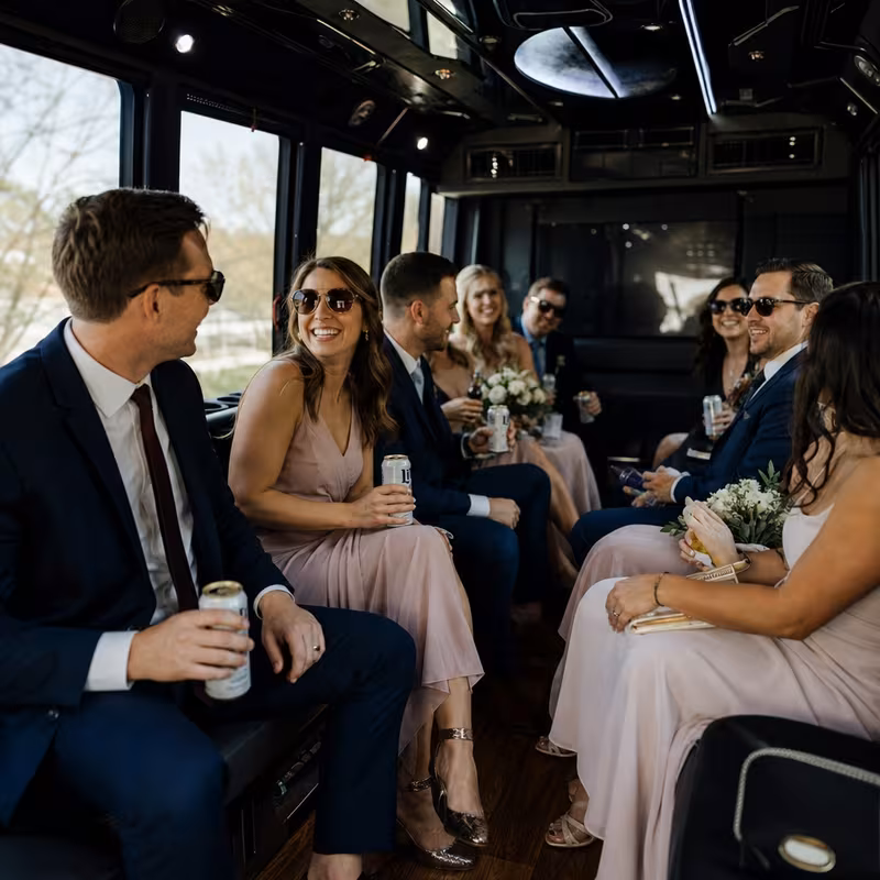 Wedding guests seated inside a Greensboro party bus
