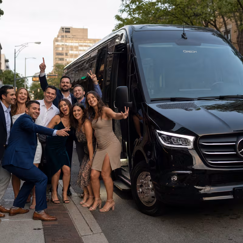 Group boarding a white charter bus for Bachelor & Bachelorette Transportation transportation in Greensboro