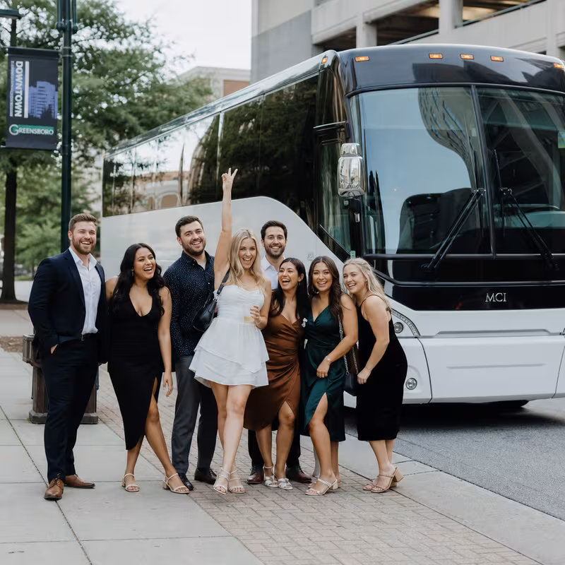 Passengers loading luggage while boarding an Greensboro group shuttle