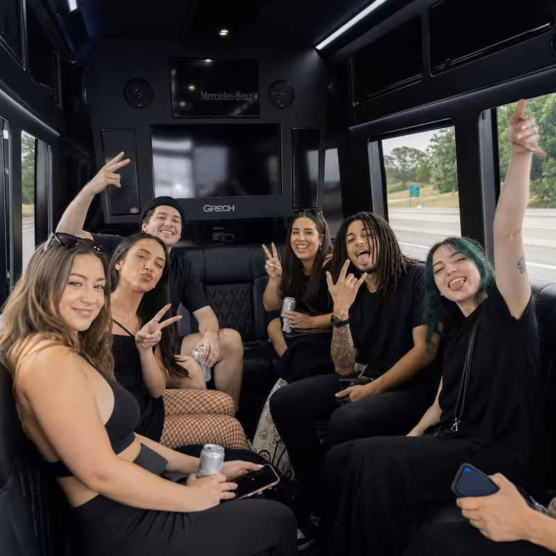Group boarding a white charter bus for Concert Transportation transportation in Greensboro