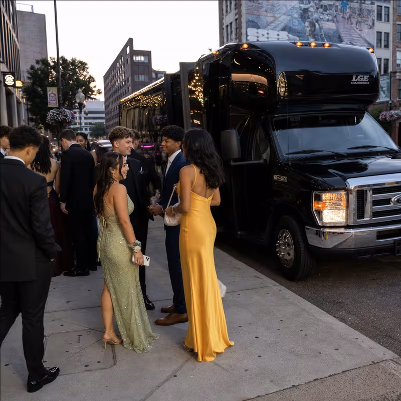 Passengers loading luggage while boarding an Greensboro group shuttle