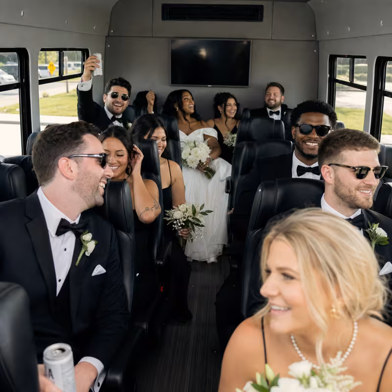 Group boarding a white charter bus for Wedding Transportation transportation in Greensboro