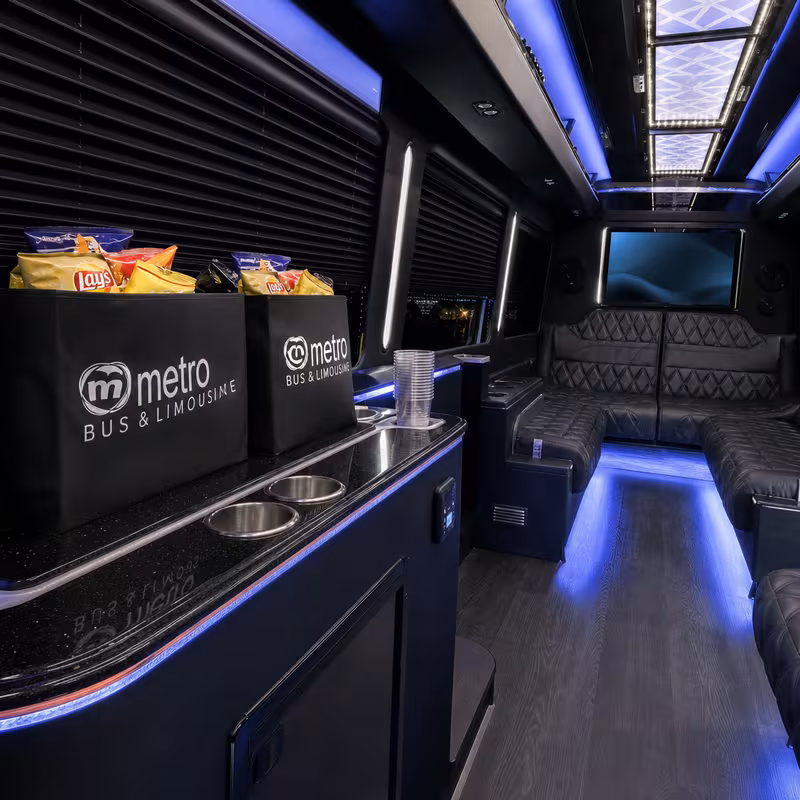 Party bus interior with wraparound leather seating and LED lighting in Greensboro